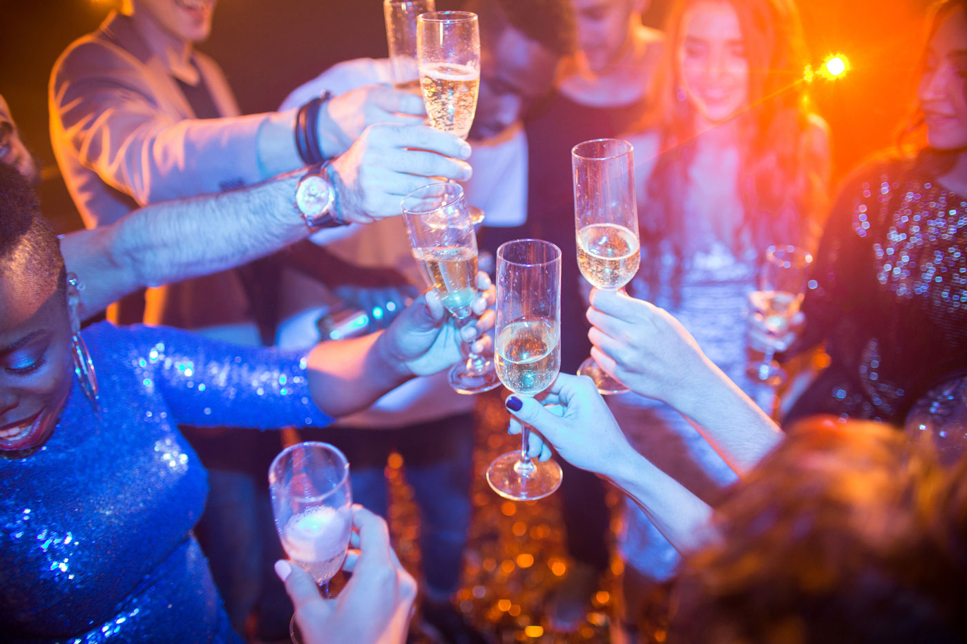 Group of people toasting with champagne at a party.
